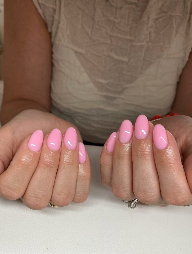 mochi pink nails with glossy milky finish on short almond shape, November 2026 manicure